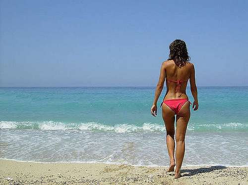 Řecká pláž a žena v plavkách